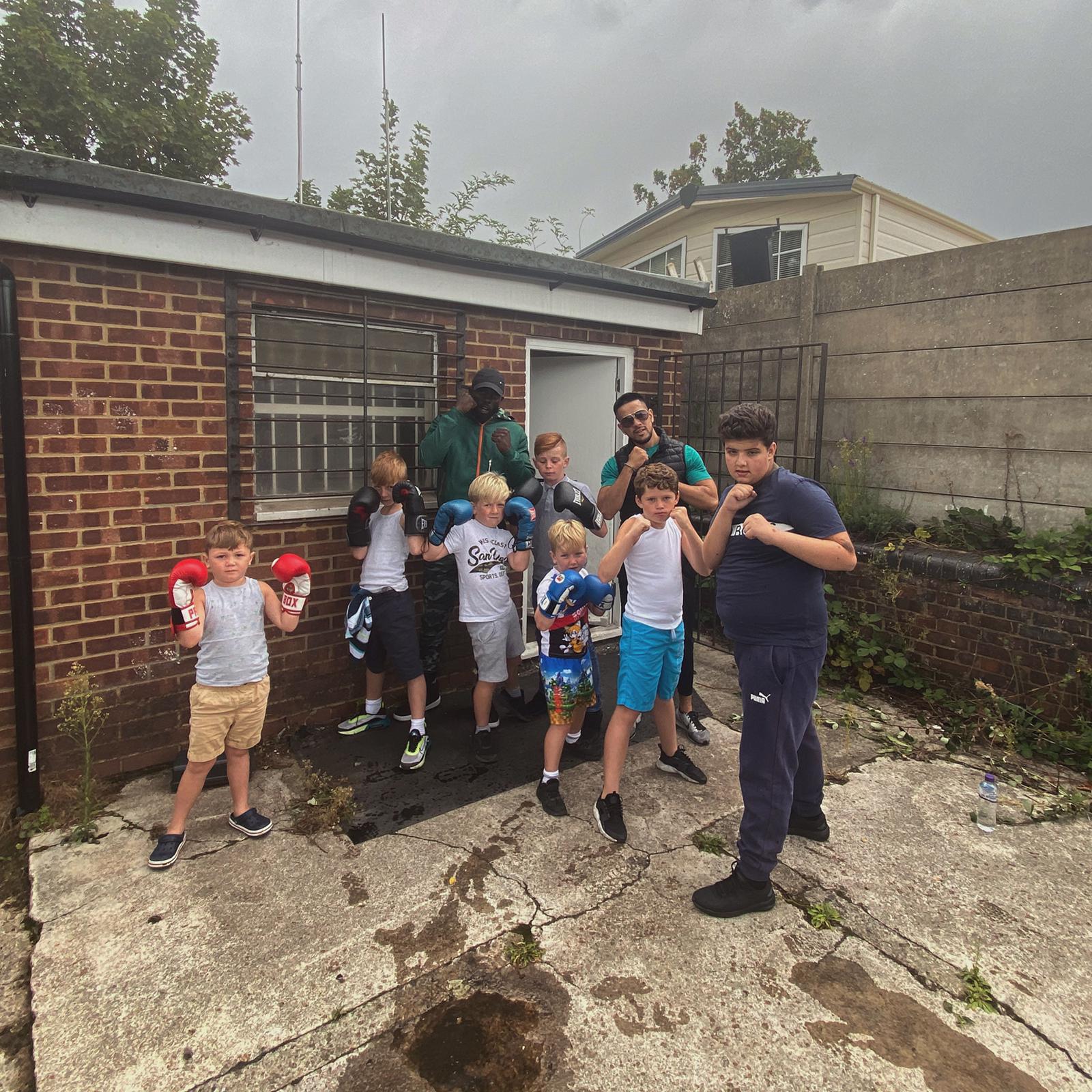 MEM coaches with a group of young boxers after a community session