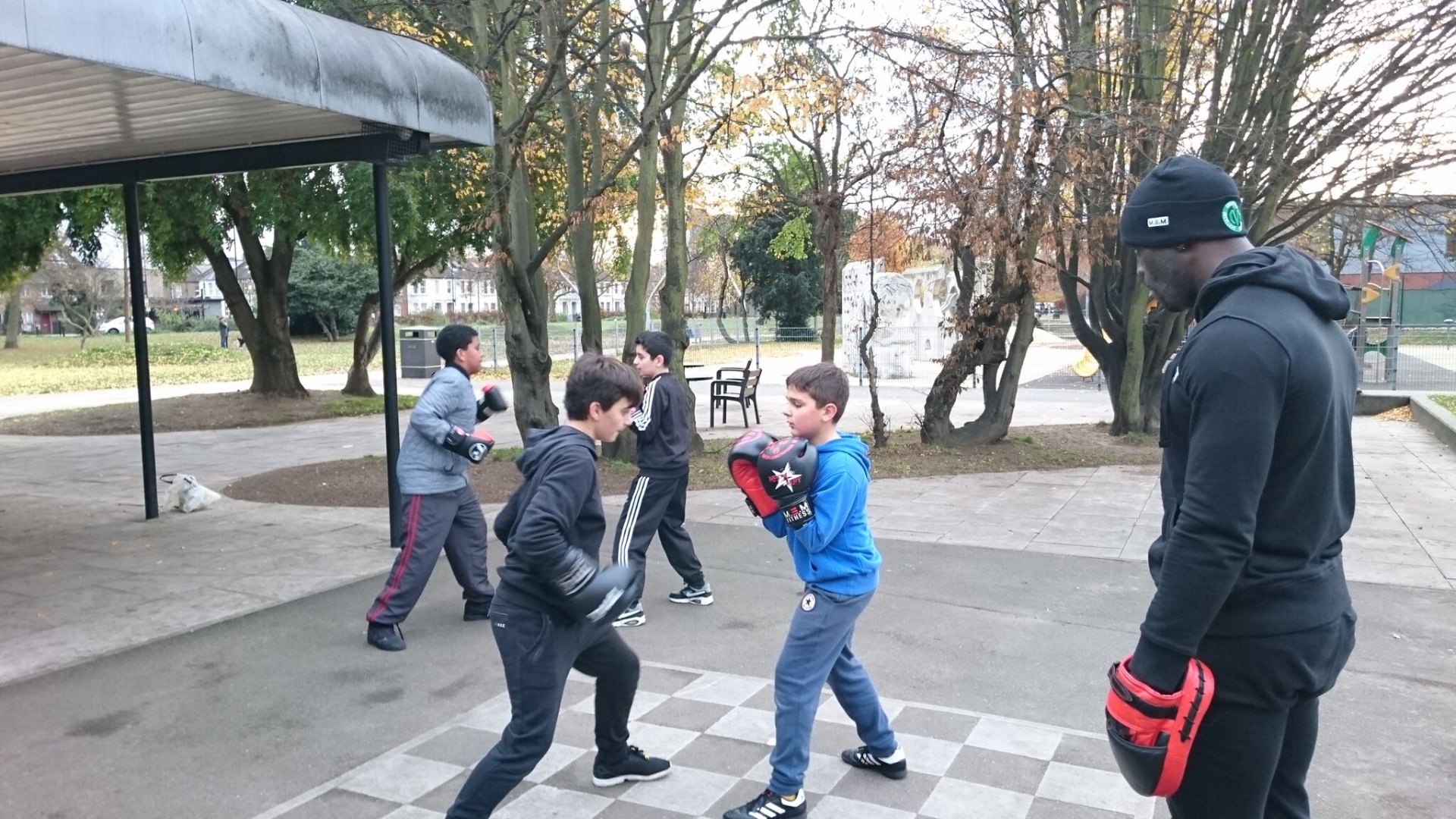 MEM coach leading a youth boxing session in a London park