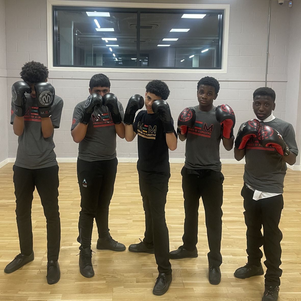 Young people in MEM Academy t-shirts during a fitness mentoring session.